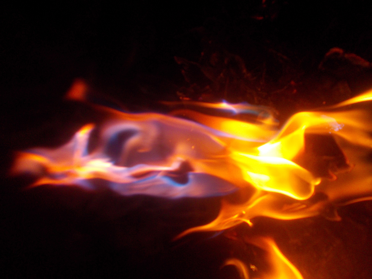 Bright burning flame against dark background